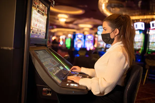 BB444 Mobile Casino — Play anytime, anywhere A player using their smartphone during a festive local event, representing BB444’s fully mobile-friendly casino.